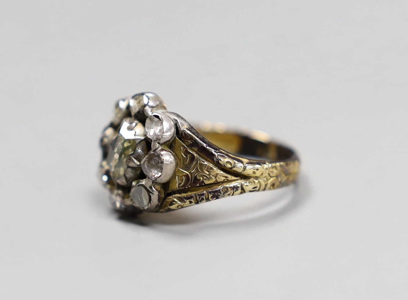 An early 19th century gold overlay and silver, rose diamond cluster ring, size P, gross 6.3 grams